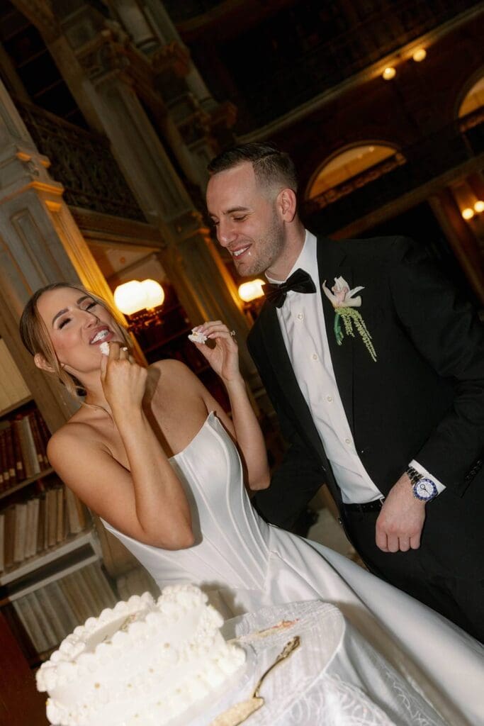 George Peabody Library wedding bride and groom enjoying wedding cake