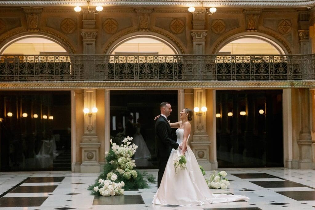 George Peabody Library wedding bride and groom enjoying their wedding with beautiful florals