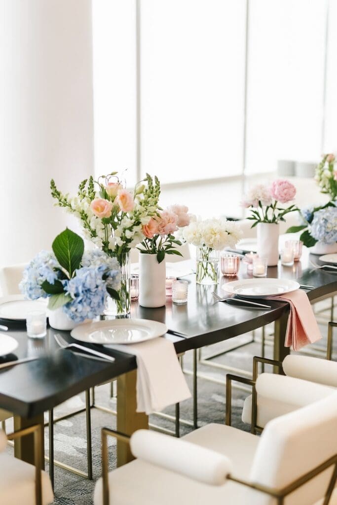 floor to ceiling windows at the four seasons baltimore entertainment lounge with pastel floral decorations on the table