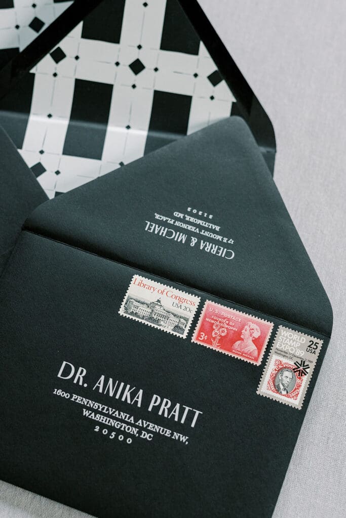 black wedding invitation envelopes with vintage stamps and envelope liners